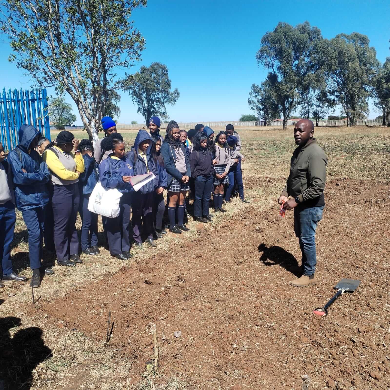 Speaking to a group on the farm